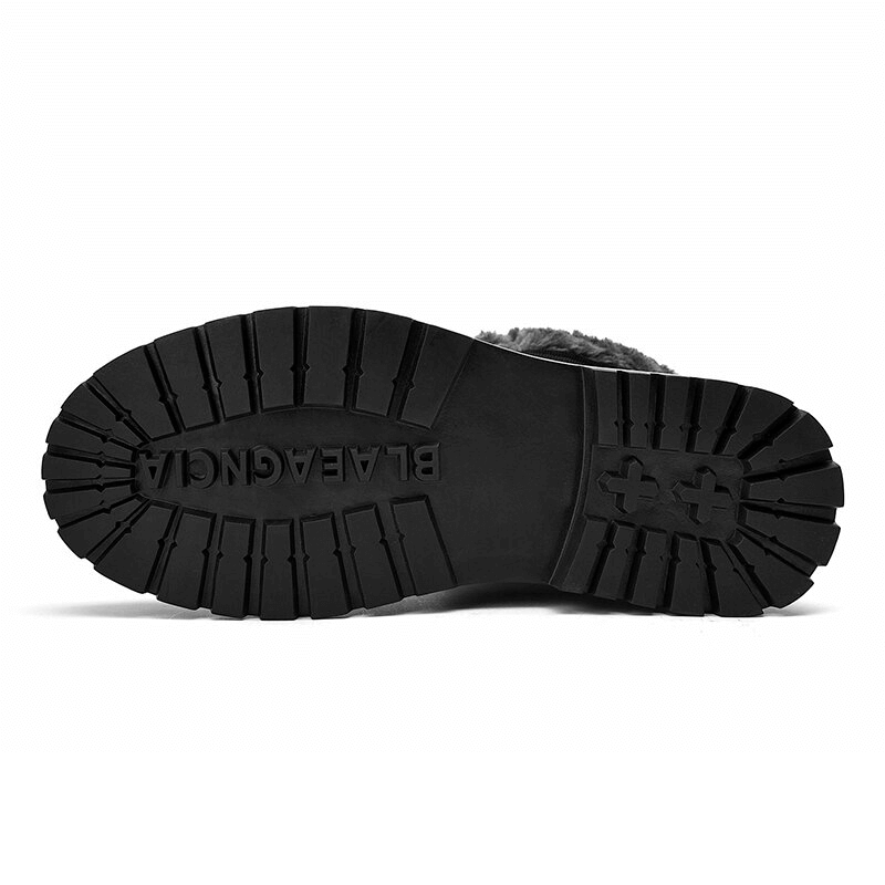 Close-up of the non-slip rubber outsole of leather hiking boots, showcasing traction and durability for all-weather conditions.